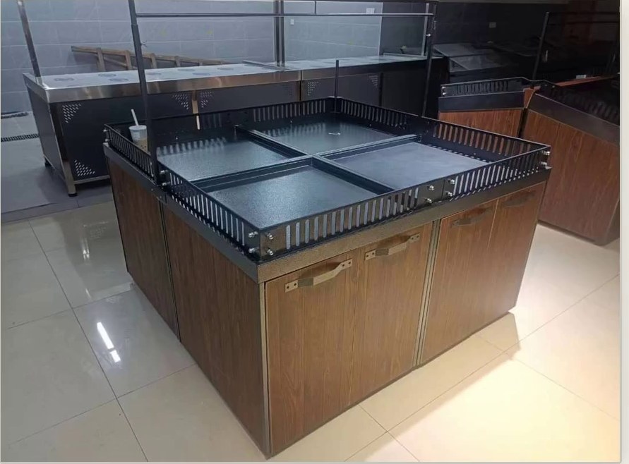Produce display island with built-in storage cabinets below