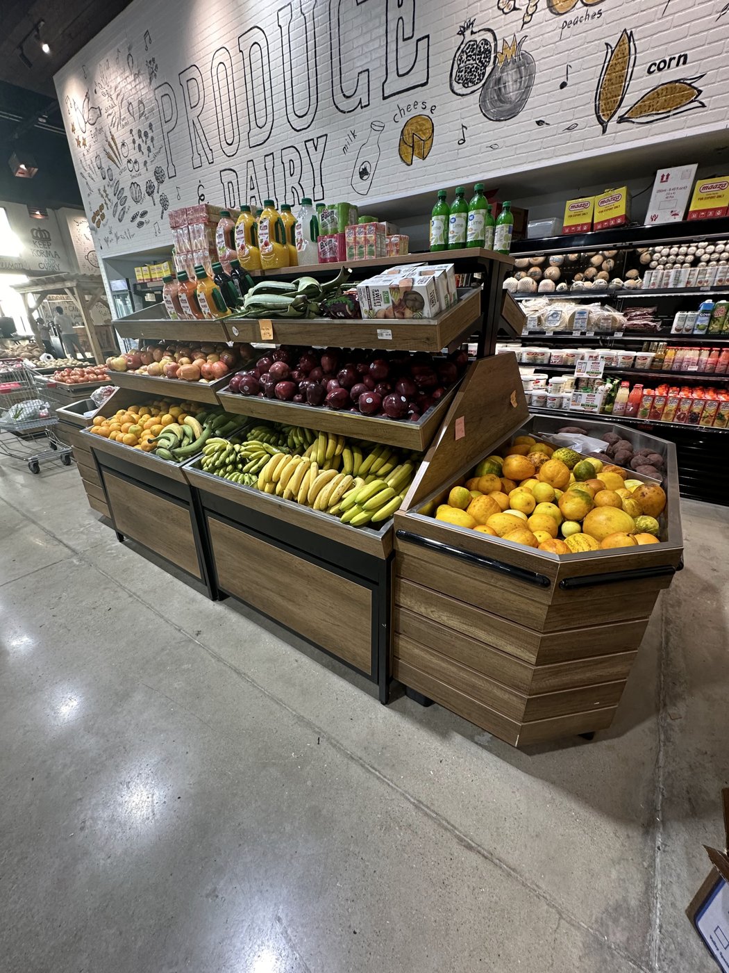 Produce display island stocked with fruit in a grocery store